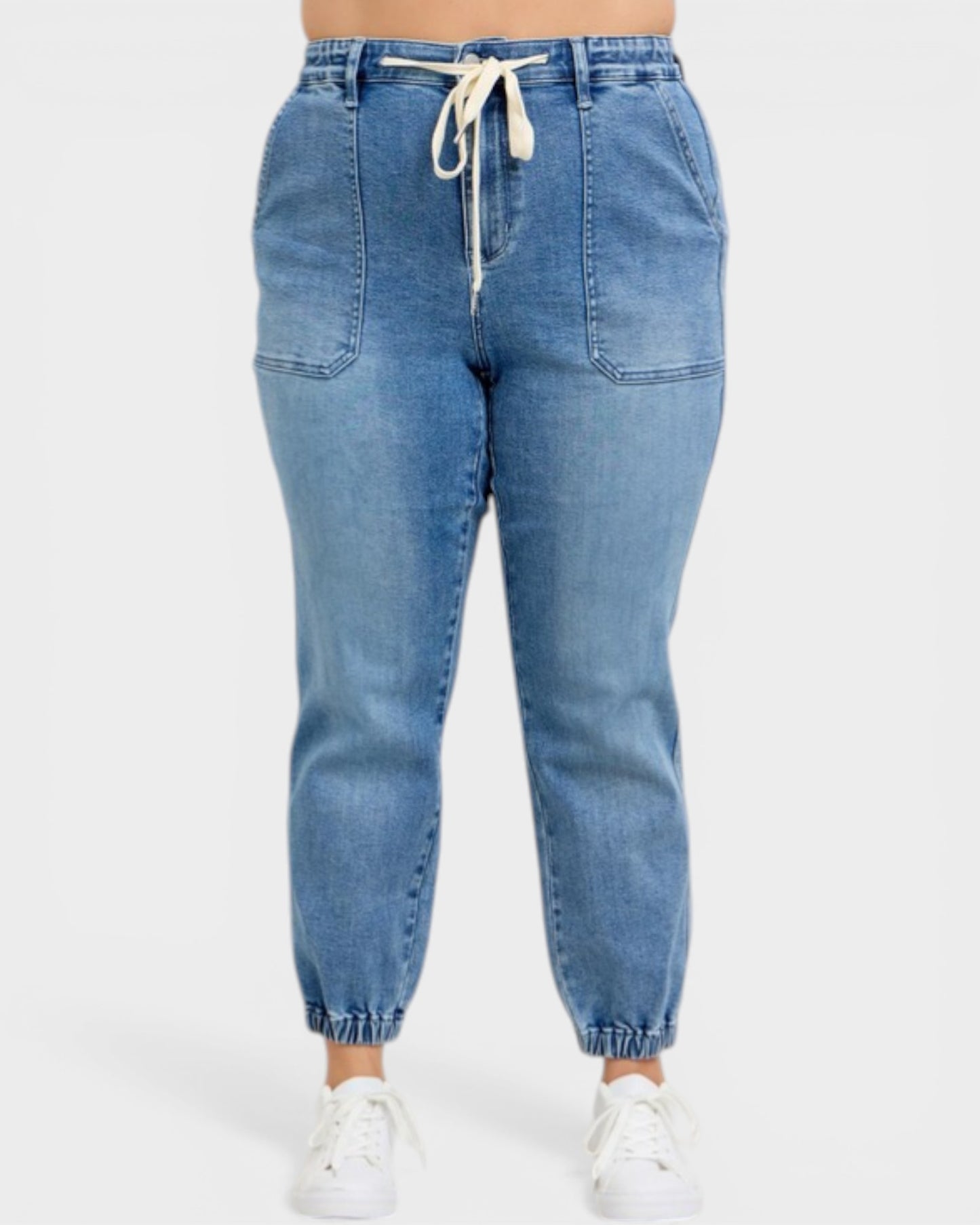 Blue denim jogger pants with a drawstring on a white background