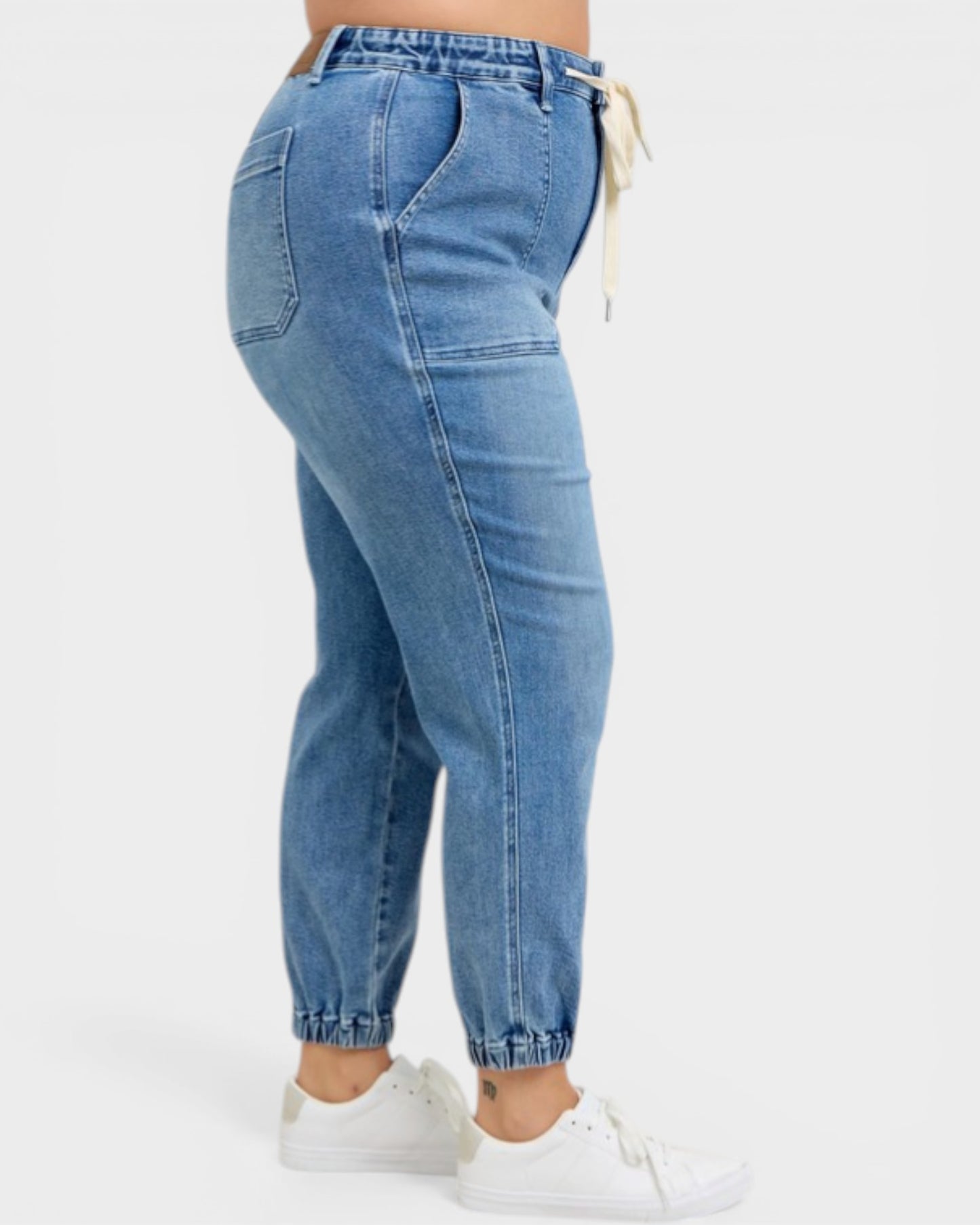 Blue jeans worn by a person on a white background