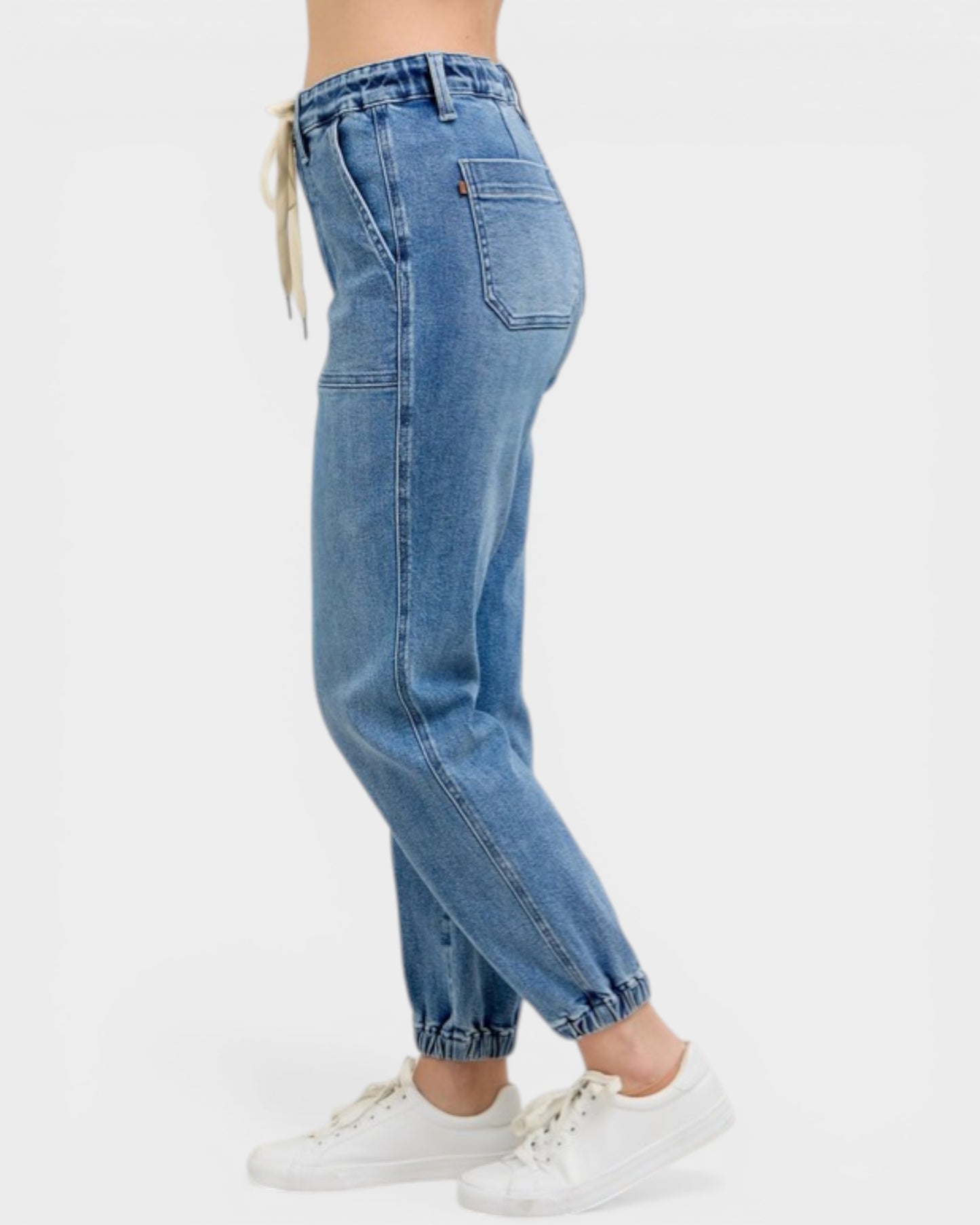 Blue jeans worn by a person on a white background