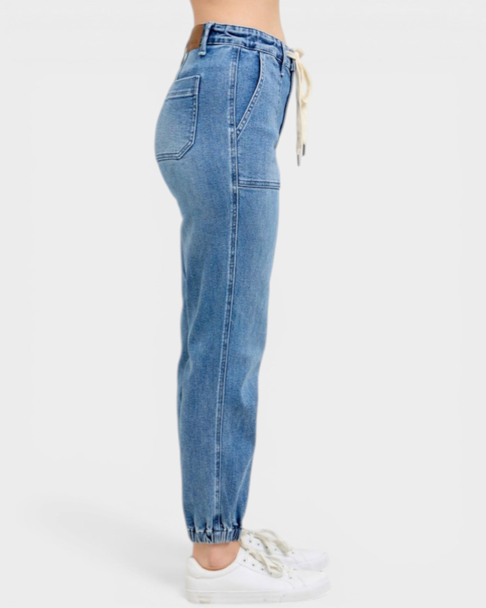 Blue jeans worn by a person on a white background