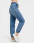 Blue jeans worn by a person on a white background