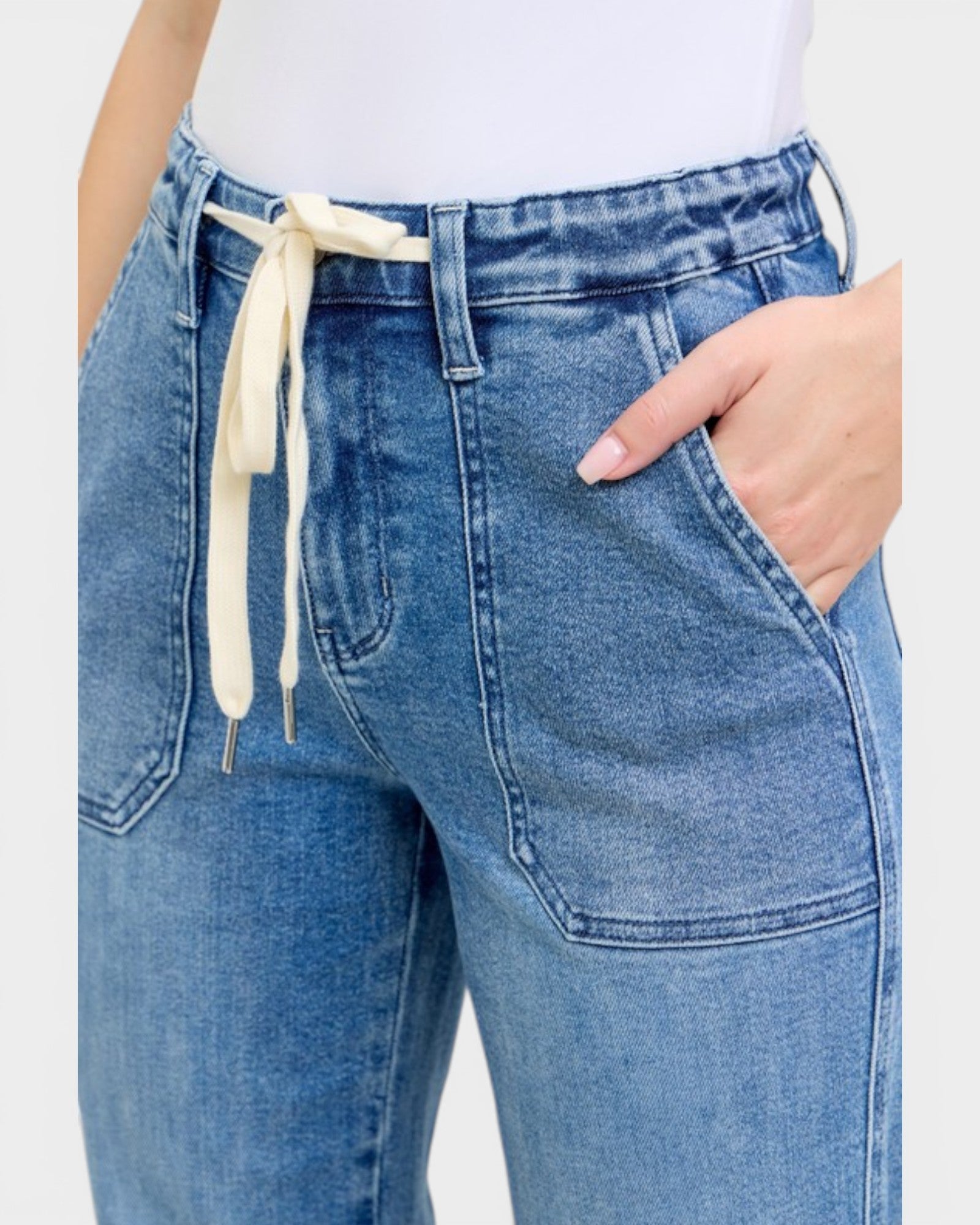 Blue jeans with a drawstring waist on a white background