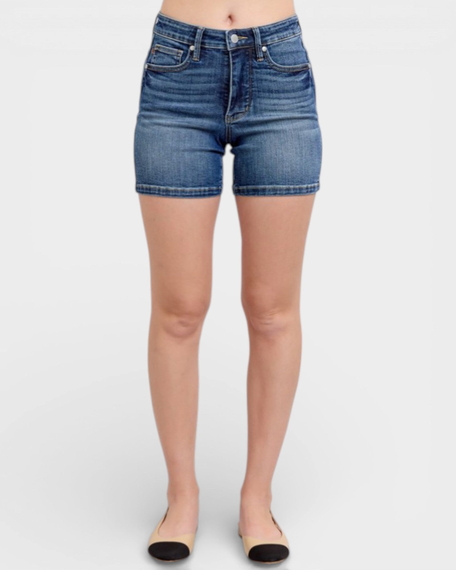 Denim shorts worn by a person on a white background
