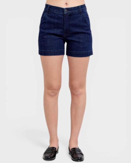 Person wearing dark blue denim shorts on a white background