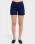 Person wearing dark blue denim shorts on a white background