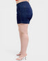Denim shorts worn by a person on a white background
