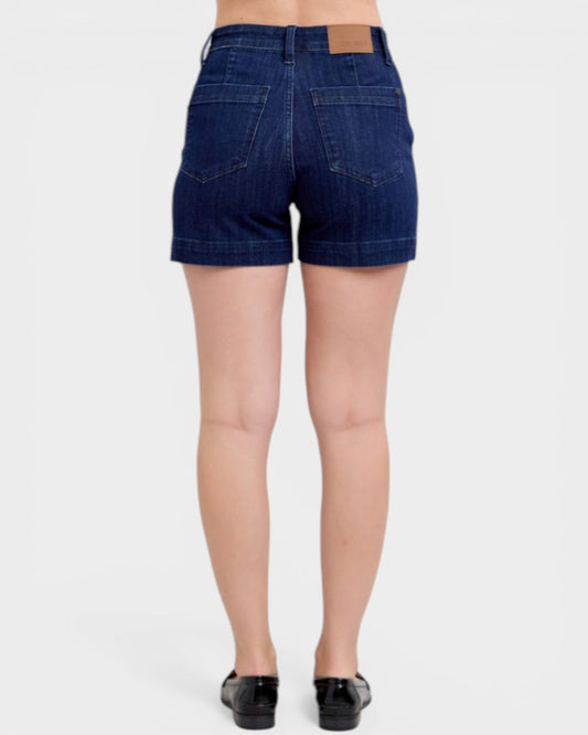 Denim shorts worn by a person on a white background