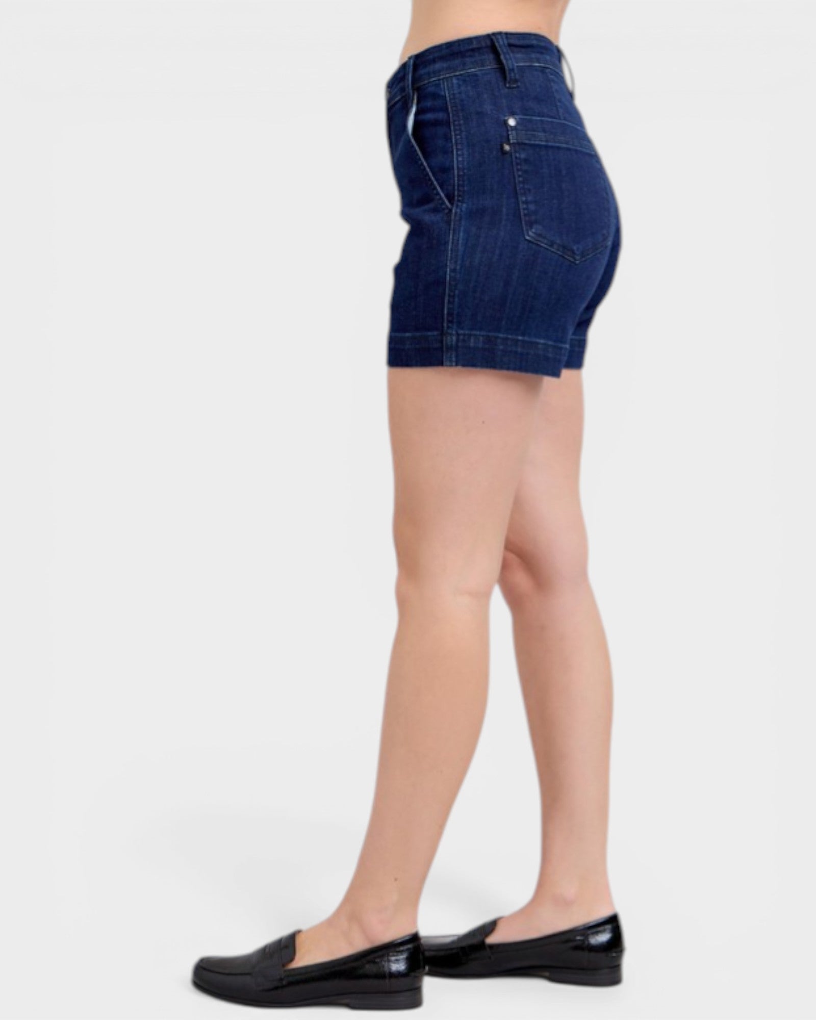 Denim shorts worn by a person on a white background