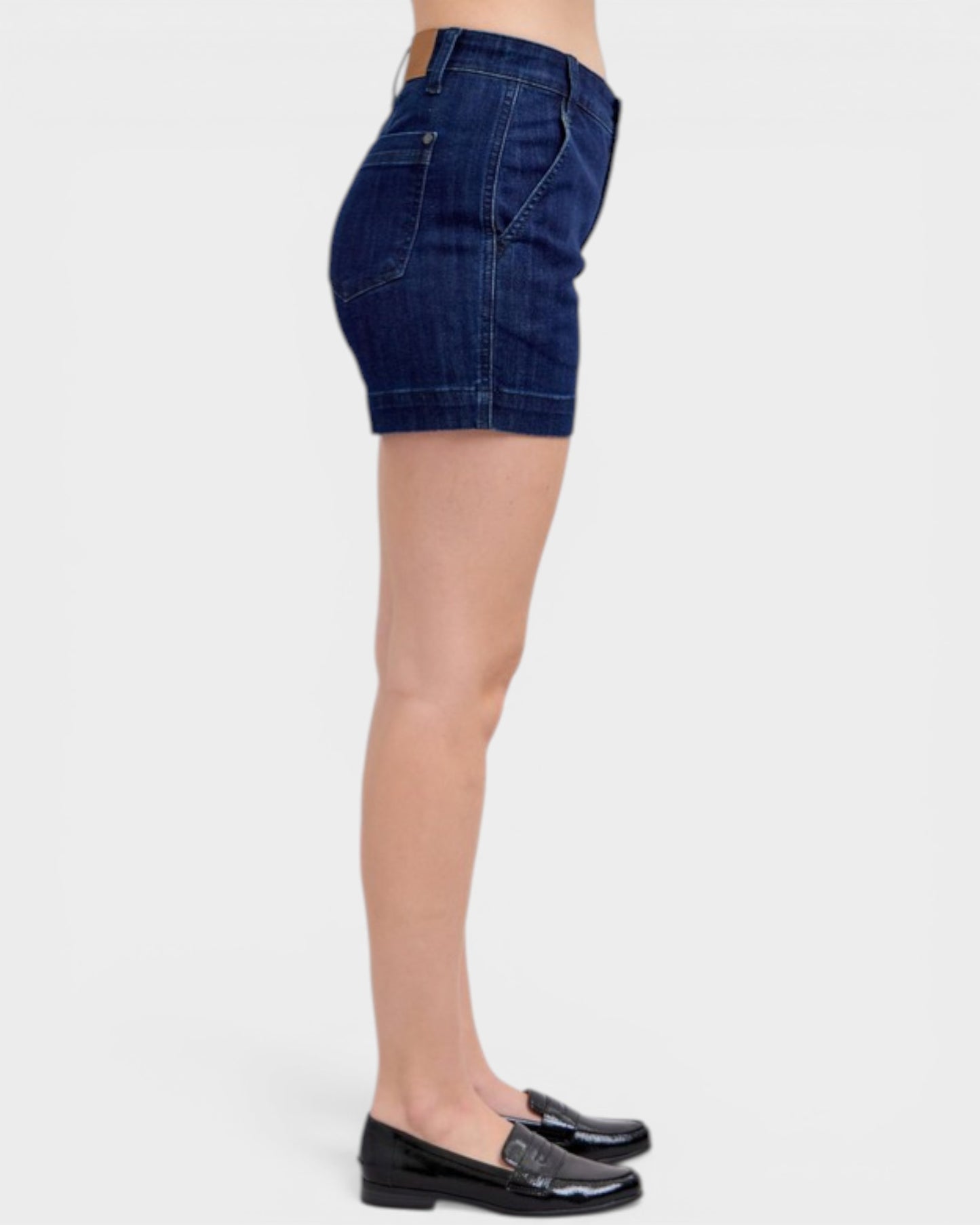 Denim shorts worn by a person on a white background