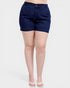 Person wearing dark blue denim shorts on a white background