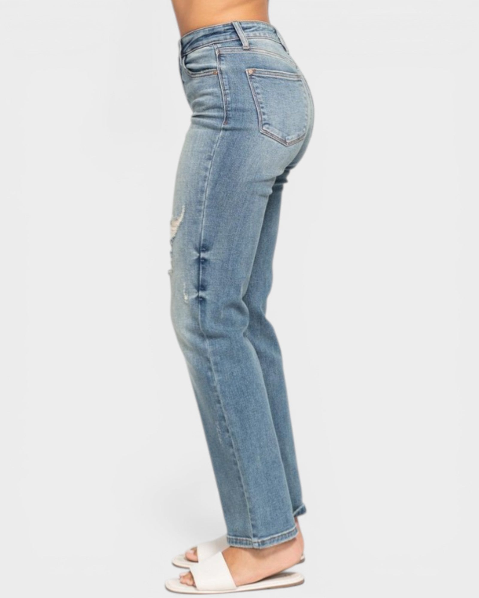 Light blue jeans worn by a person on a white background