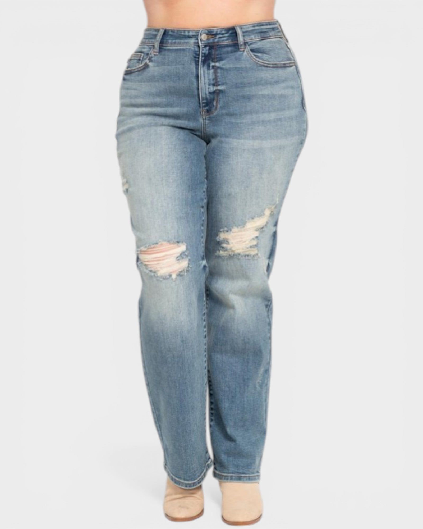 Blue jeans with distressing on a white background