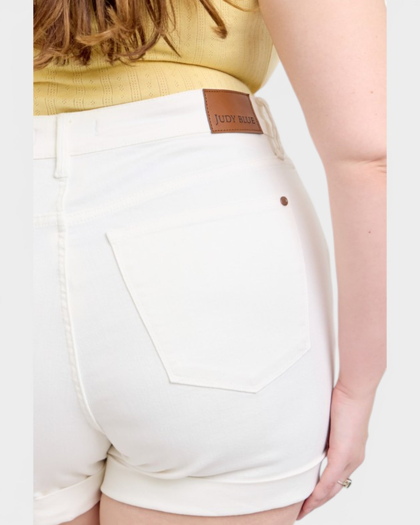 White shorts with a brand label on a plain background