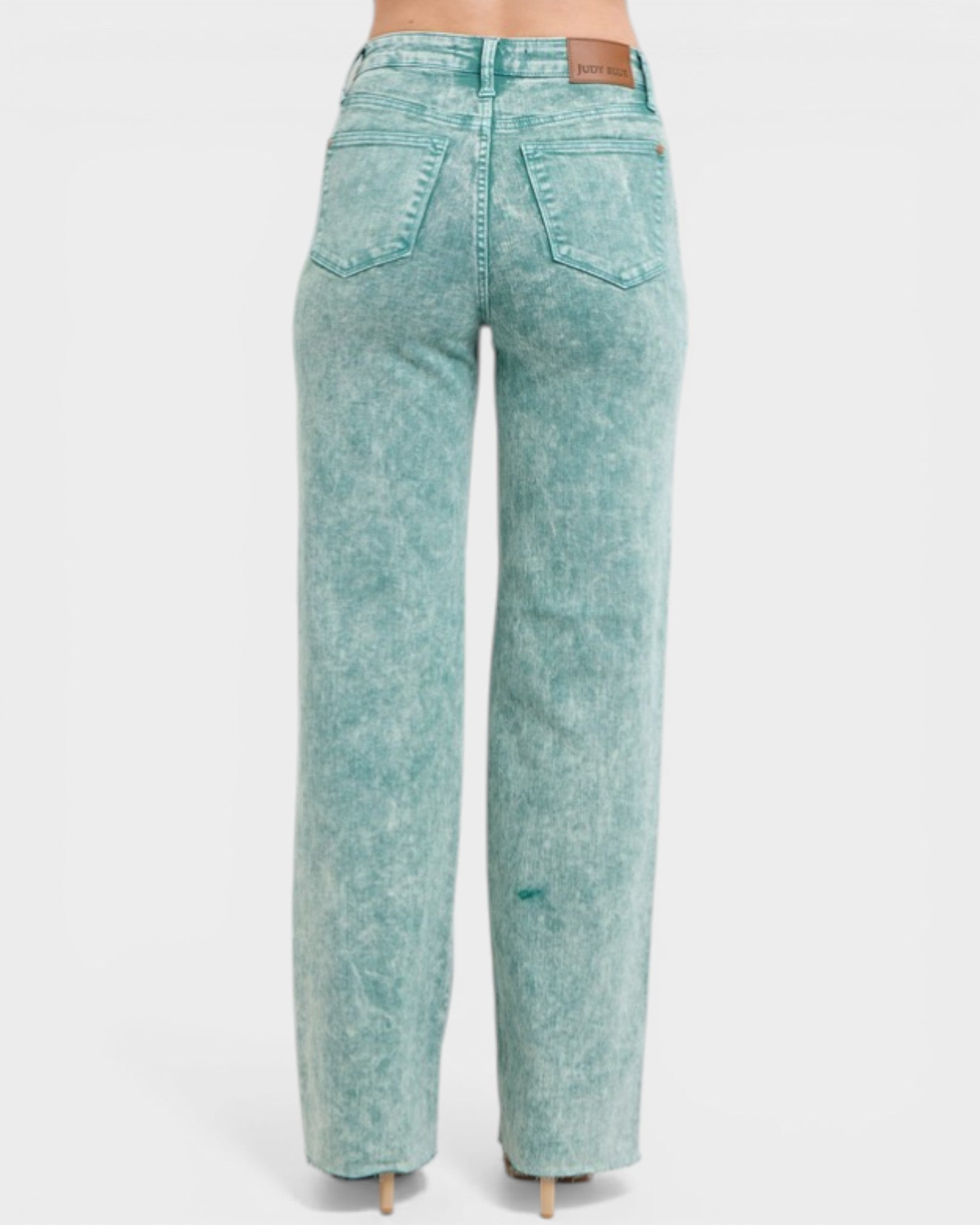Teal acid-wash jeans on a white background