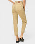 Beige pants worn by a person on a white background