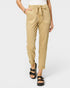 Beige pants worn by a person on a white background