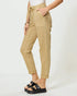 Beige pants worn by a person on a white background