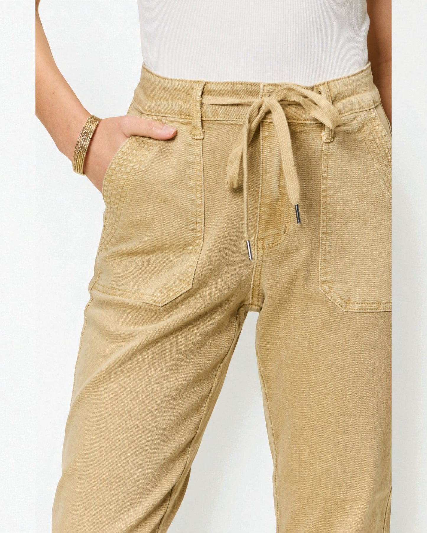 Beige pants with a drawstring waist on a white background