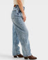 Person wearing light blue jeans on a white background
