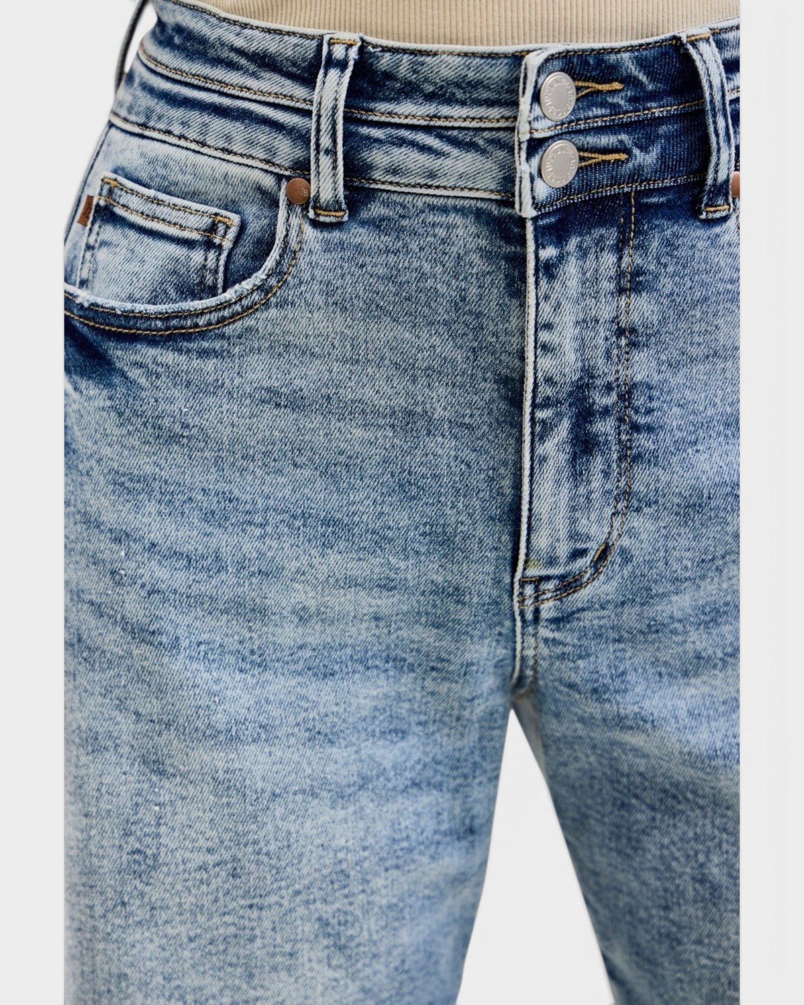 Close-up of blue jeans with a light gray background