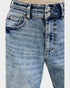 Close-up of blue jeans with a light gray background