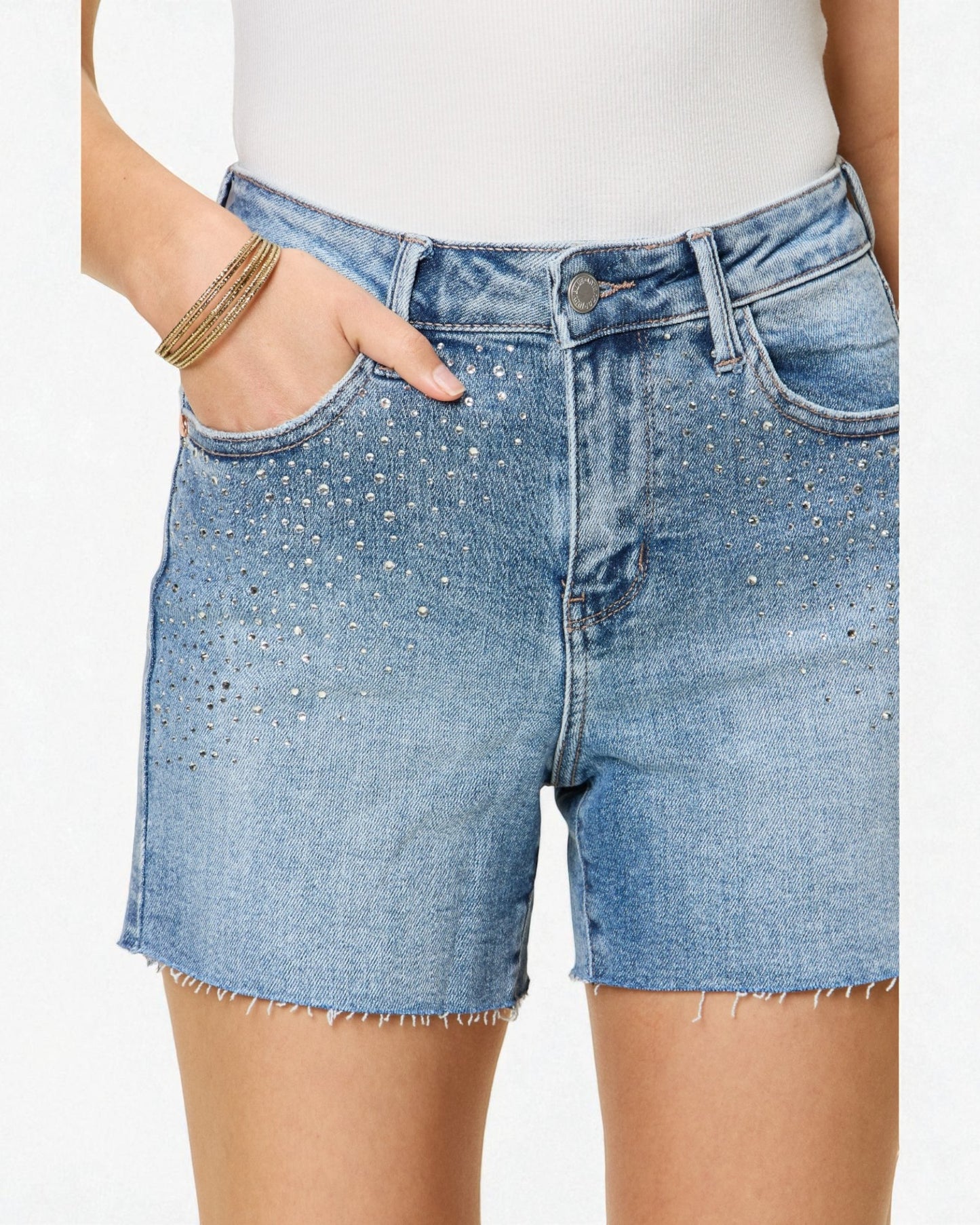 Blue denim shorts worn by a person on a white background