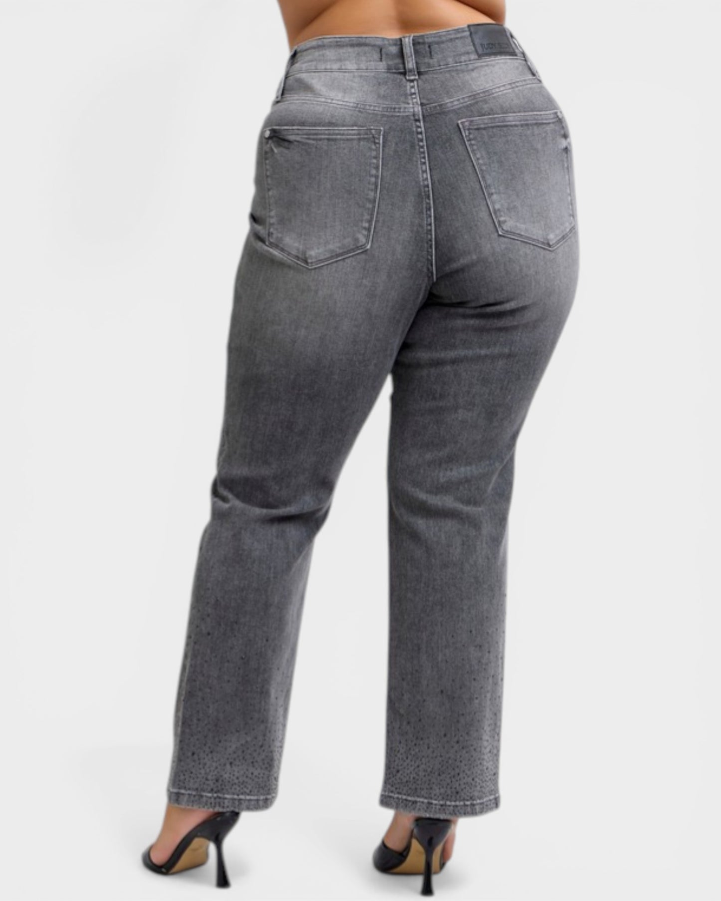 Gray jeans worn by a person on a white background
