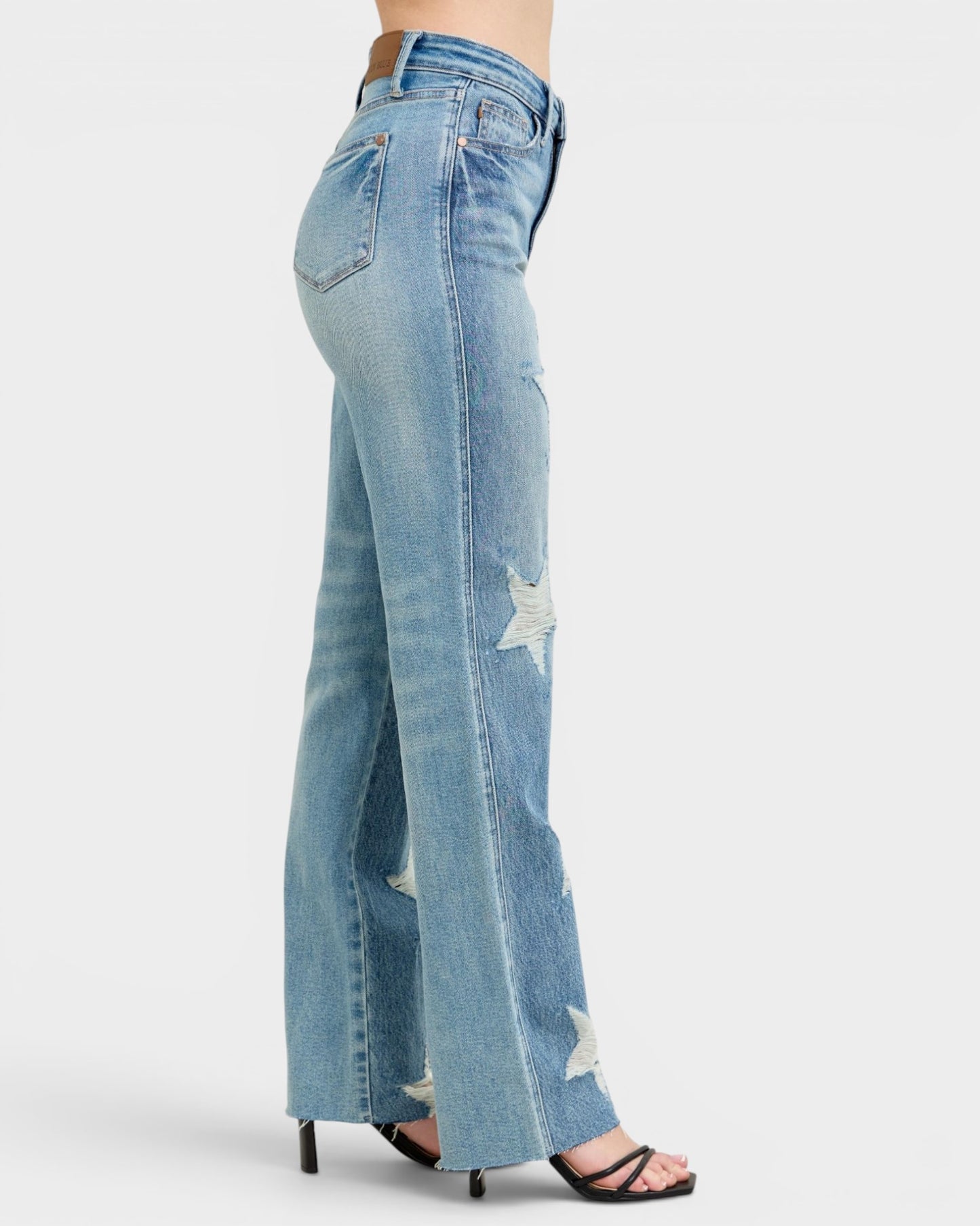 Light blue jeans with a slight distressed look on a white background
