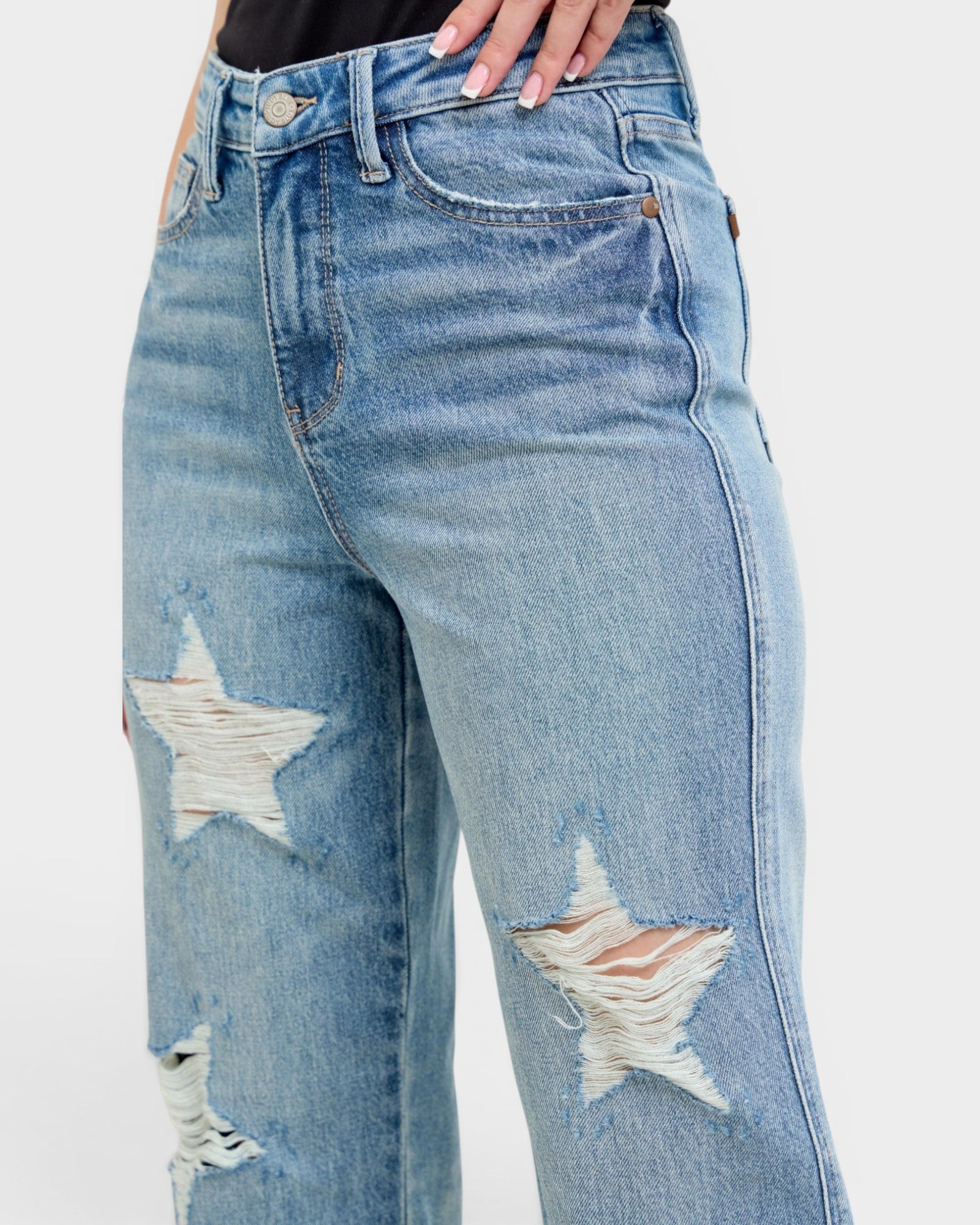 Blue jeans with star designs on a white background