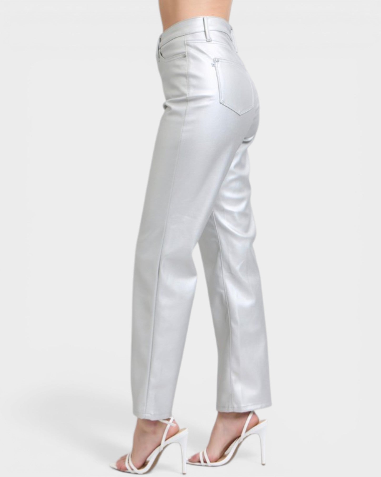 Silver pants worn by a person on a white background