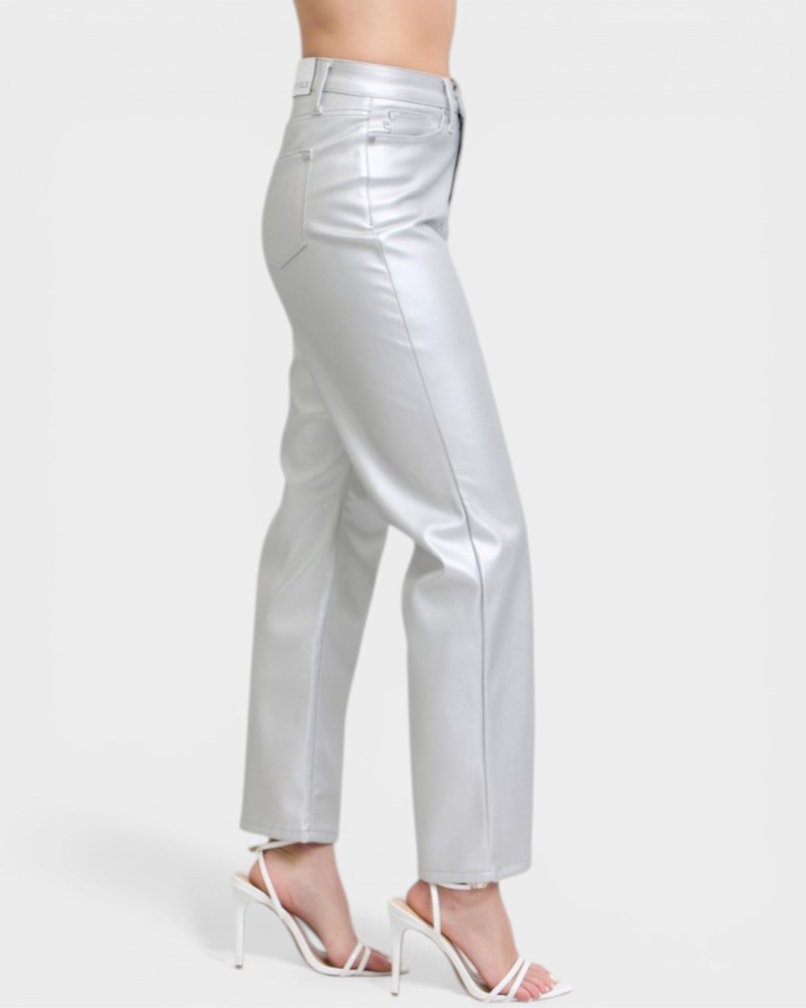 Silver metallic pants worn by a person on a white background