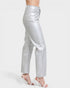 Silver metallic pants worn by a person on a white background