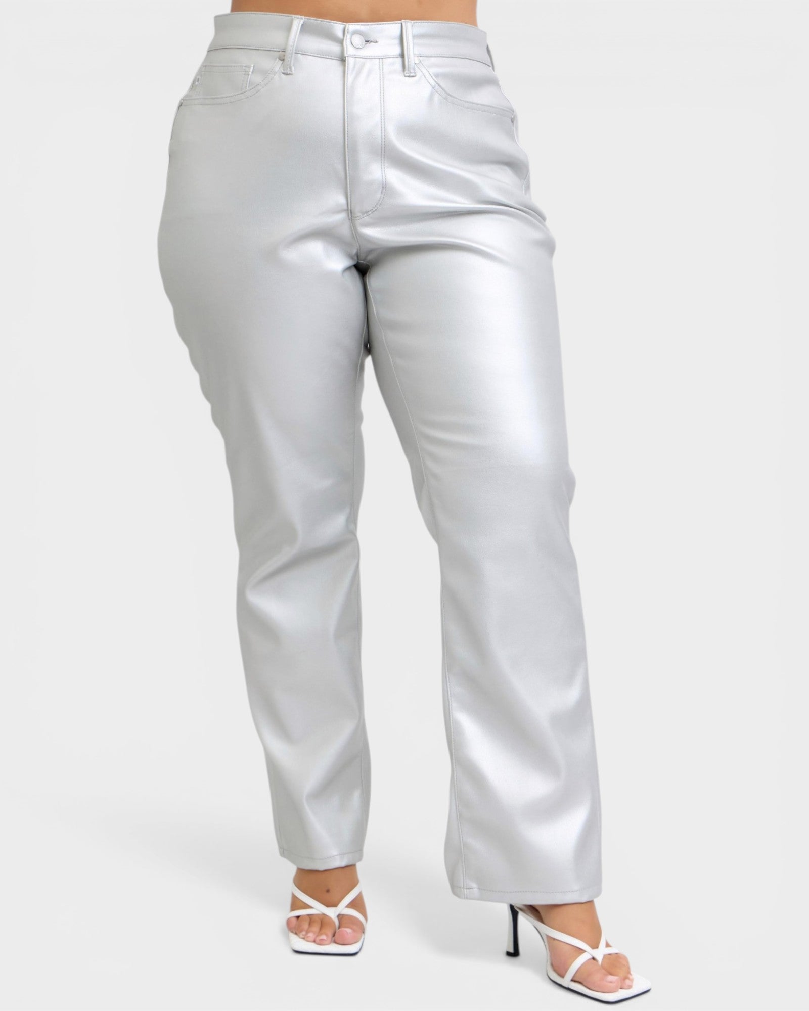 Silver metallic pants worn by a person on a white background