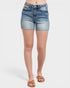 Denim shorts worn by a person on a white background