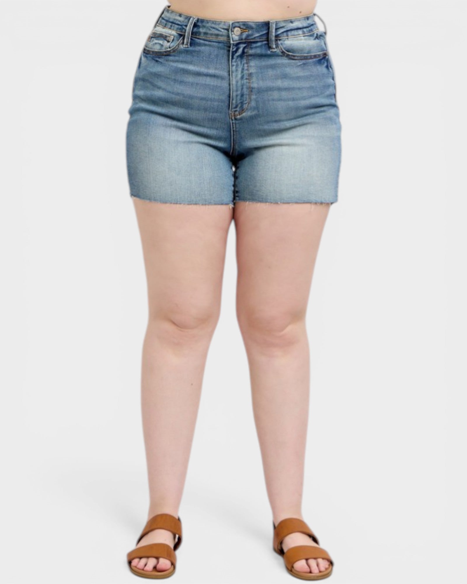 Person wearing light blue denim shorts on a white background