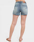 Denim shorts worn by a person on a white background