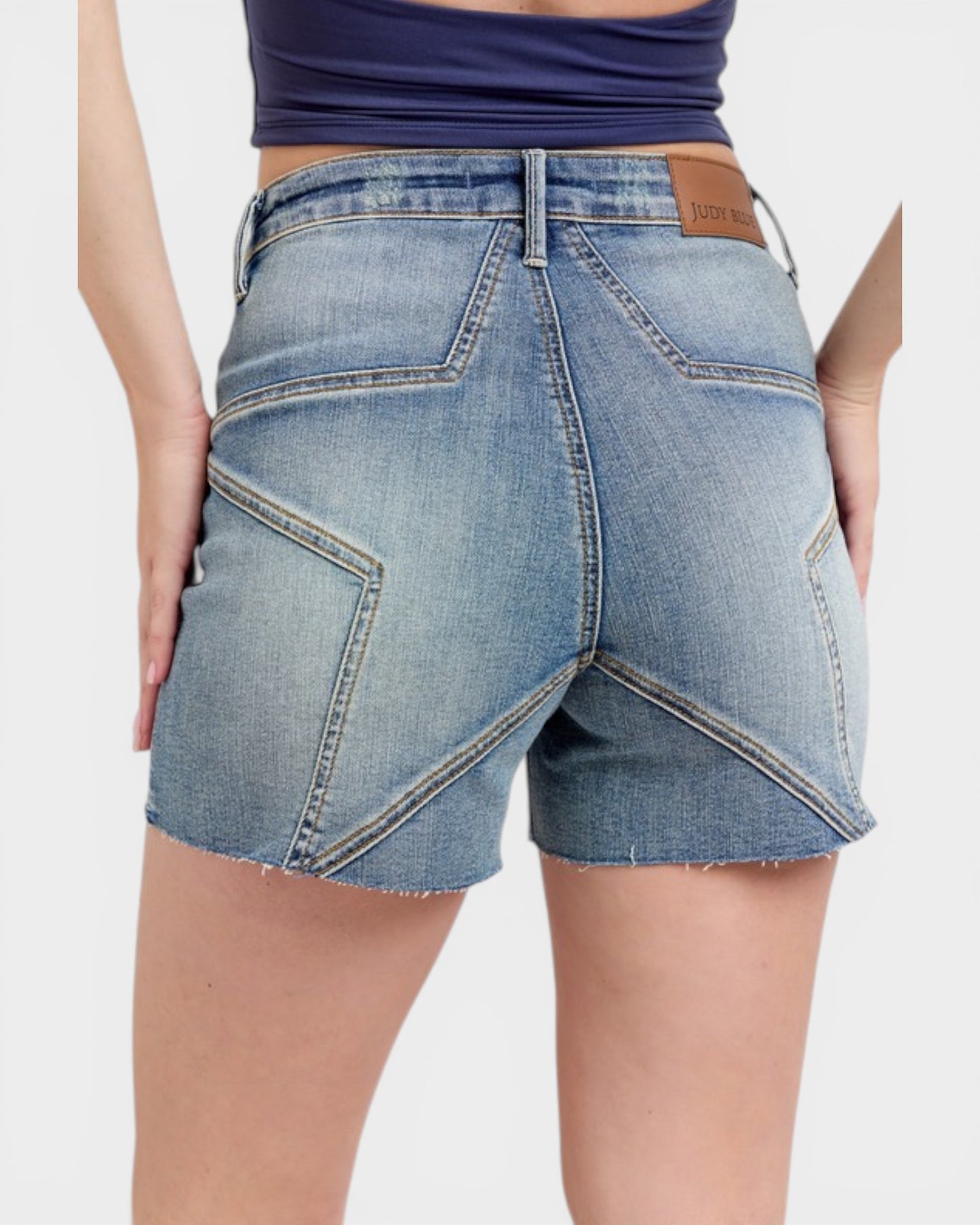 Denim shorts with a visible brand label on a plain background