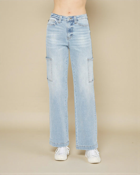 Light blue jeans worn by a person on a beige background