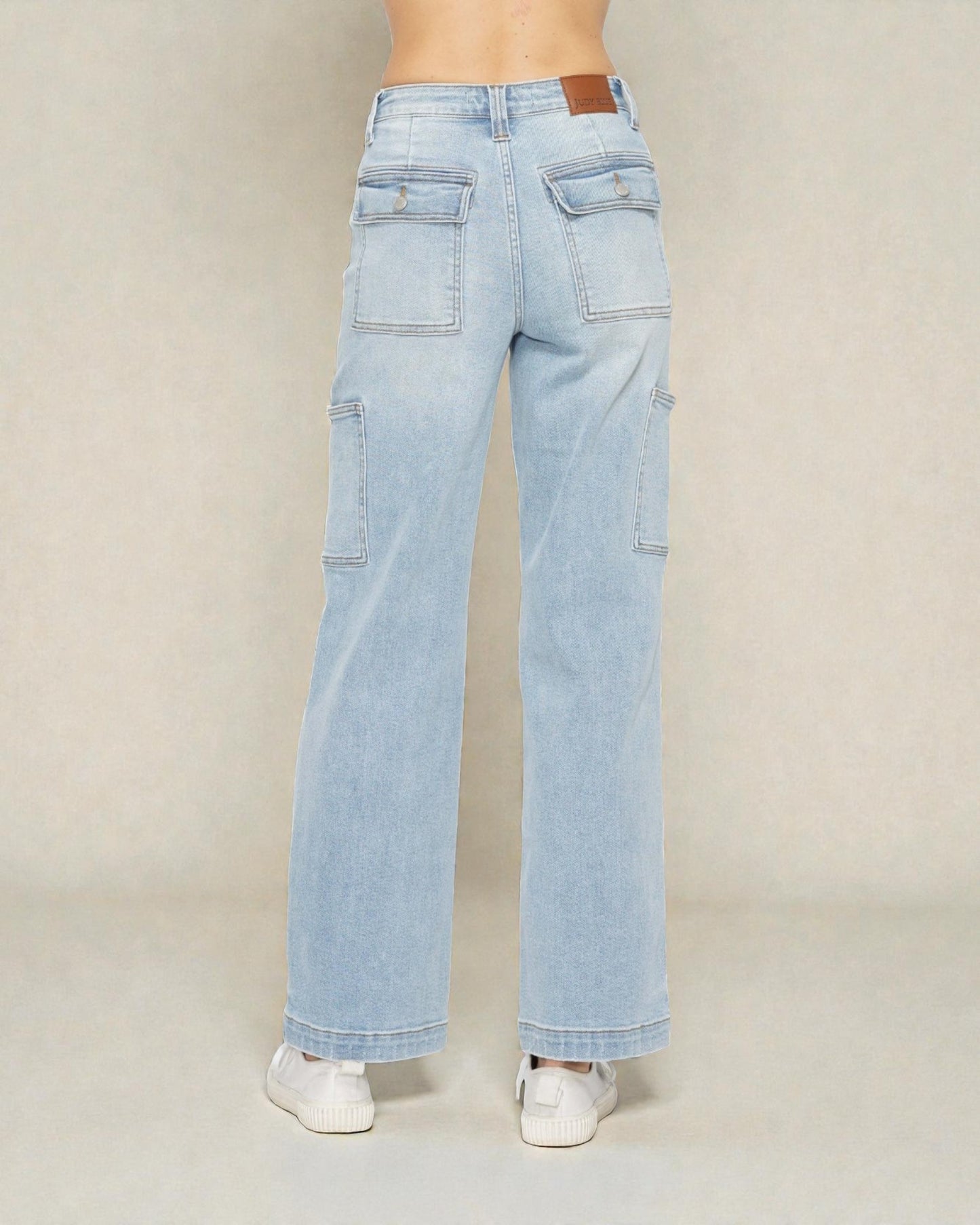 Light blue jeans worn by a person on a plain background