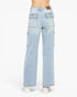 Light wash blue denim cargo pants shown from the back on a model, featuring a brown leather patch on the waistband and utility cargo pockets on the legs, paired with white sneakers against a plain white background.