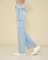 Light blue jeans worn by a person on a beige background