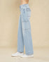 Light blue jeans worn by a person on a beige background
