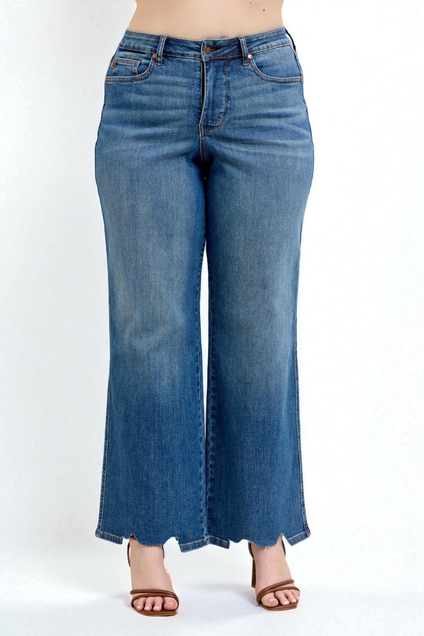 Blue jeans worn by a person on a white background
