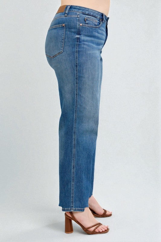 Blue jeans worn by a person on a light gray background
