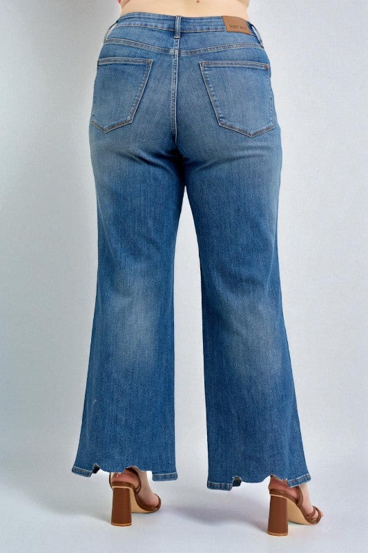 Blue jeans worn by a person on a white background
