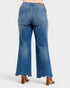 Blue jeans worn by a person on a white background