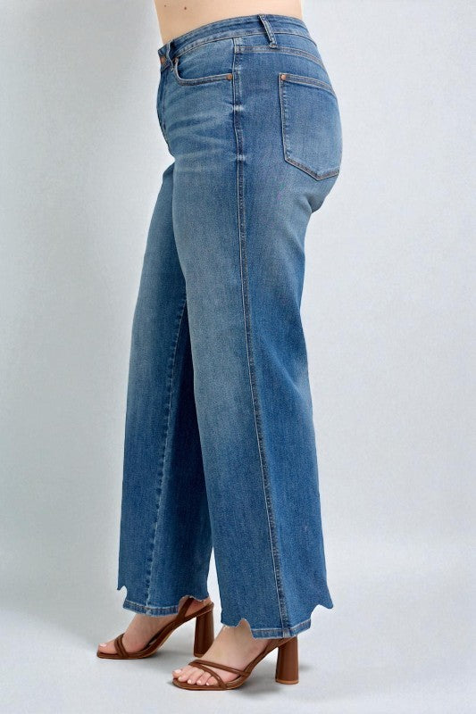Blue jeans worn by a person on a white background