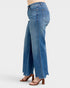 Blue jeans worn by a person on a white background