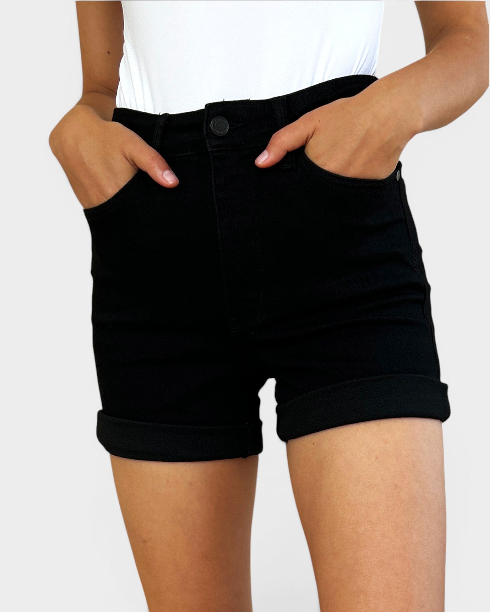 Person wearing black shorts on a white background