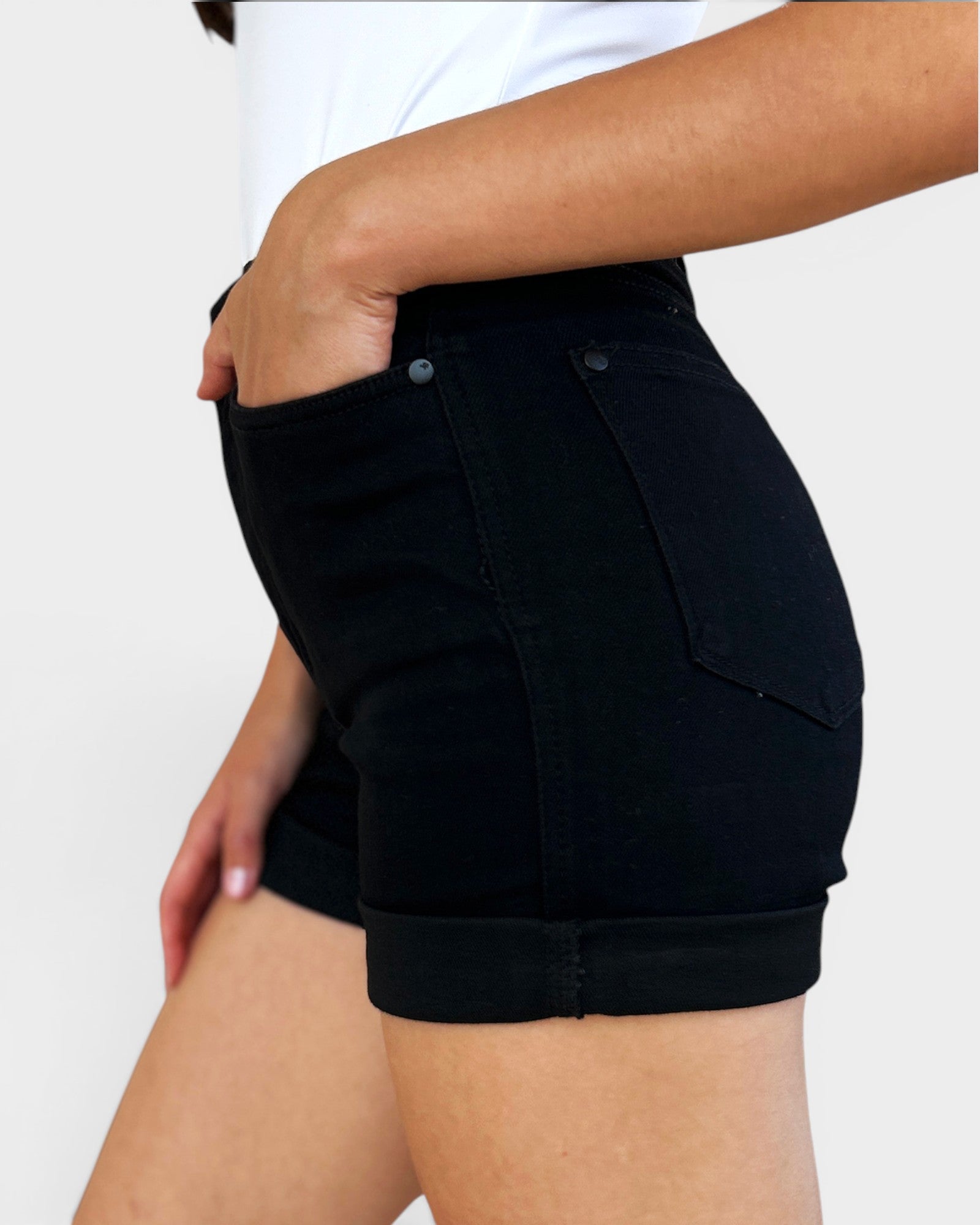 Black shorts worn by a person on a white background
